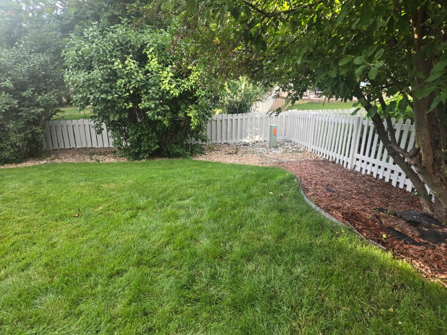 repainted white picket fence surrounding yard