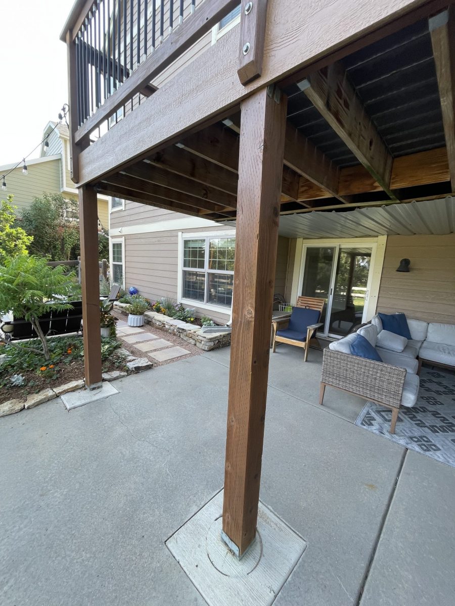 underside of stained wooden deck above patio
