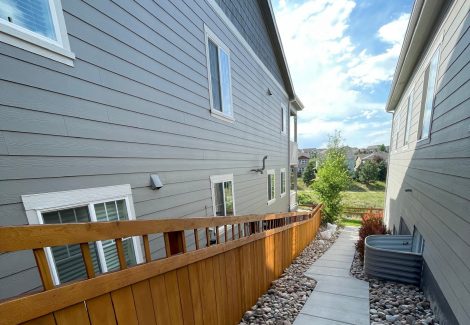 stained fence surrounding house and yard