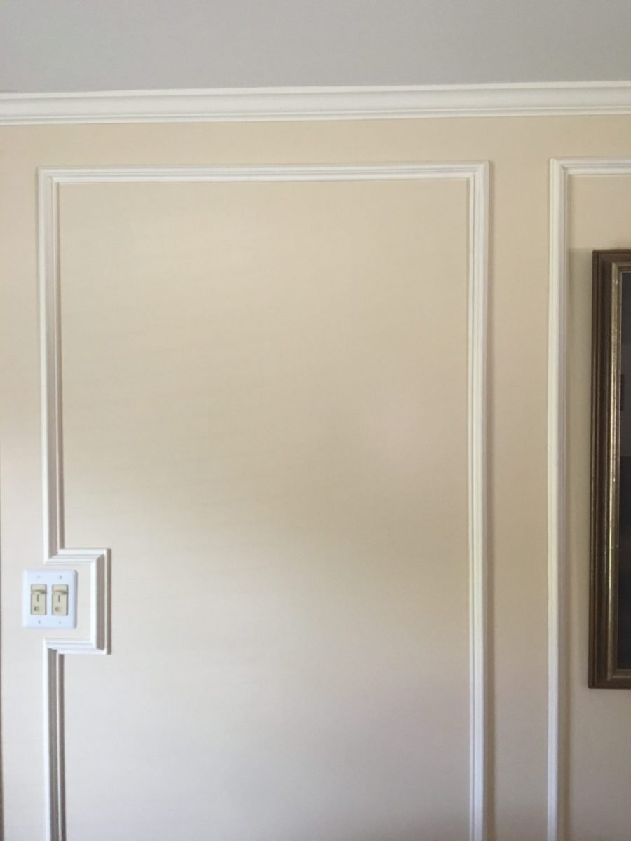 tan wall with white framed wainscoting