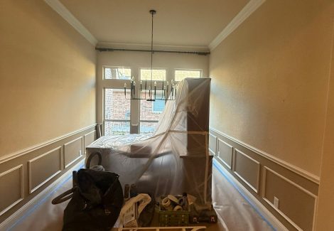 room in home with protective sheeting for painting