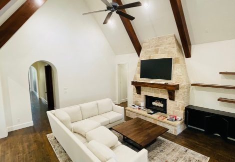 living room with vaulted ceiling and fireplace