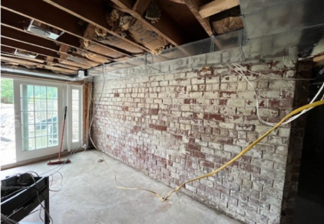 basement room with exposed brick walls
