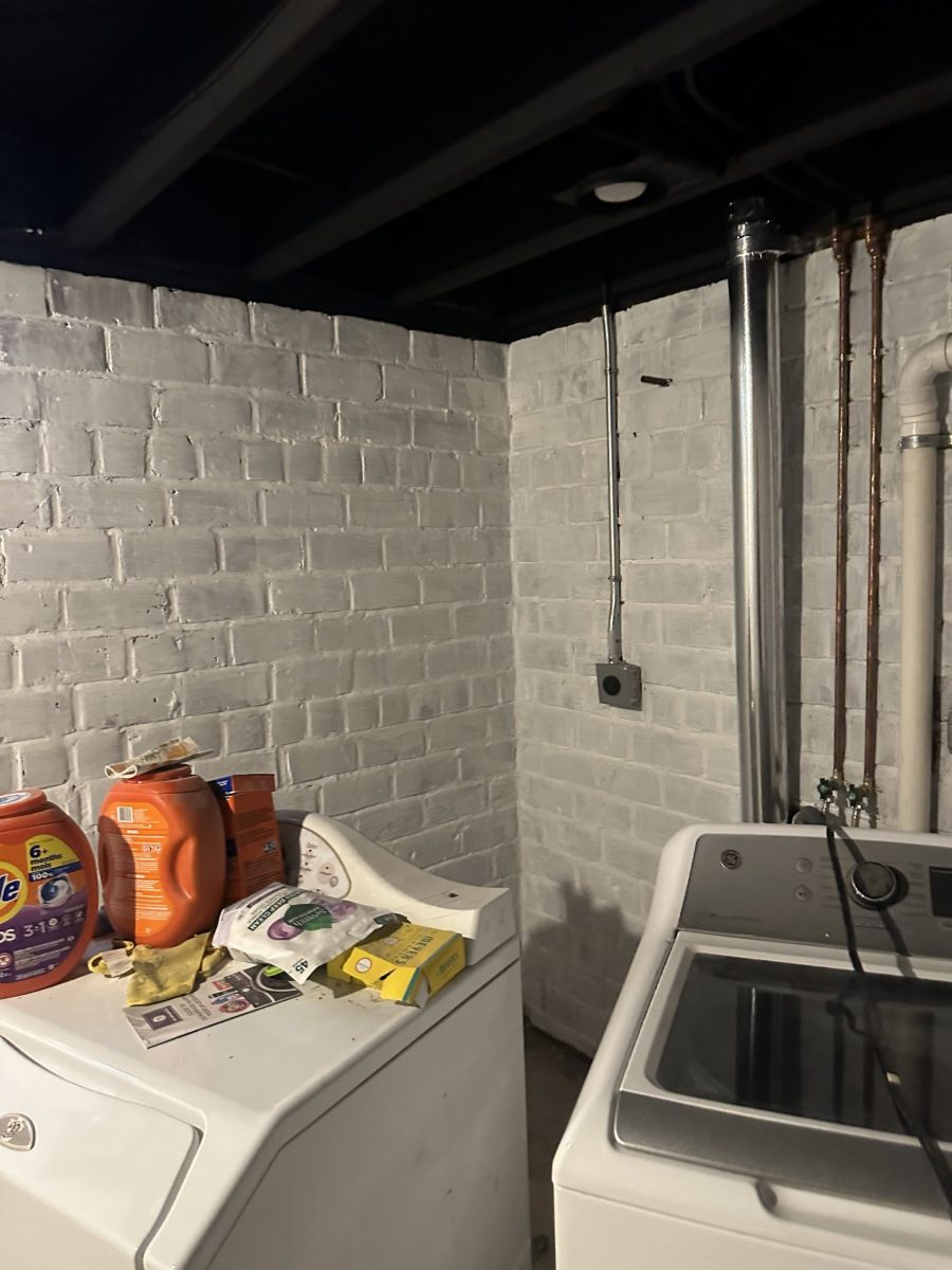 washer & dryer in room with whitewashed brick walls and black painted ceiling beams Preview Image 1