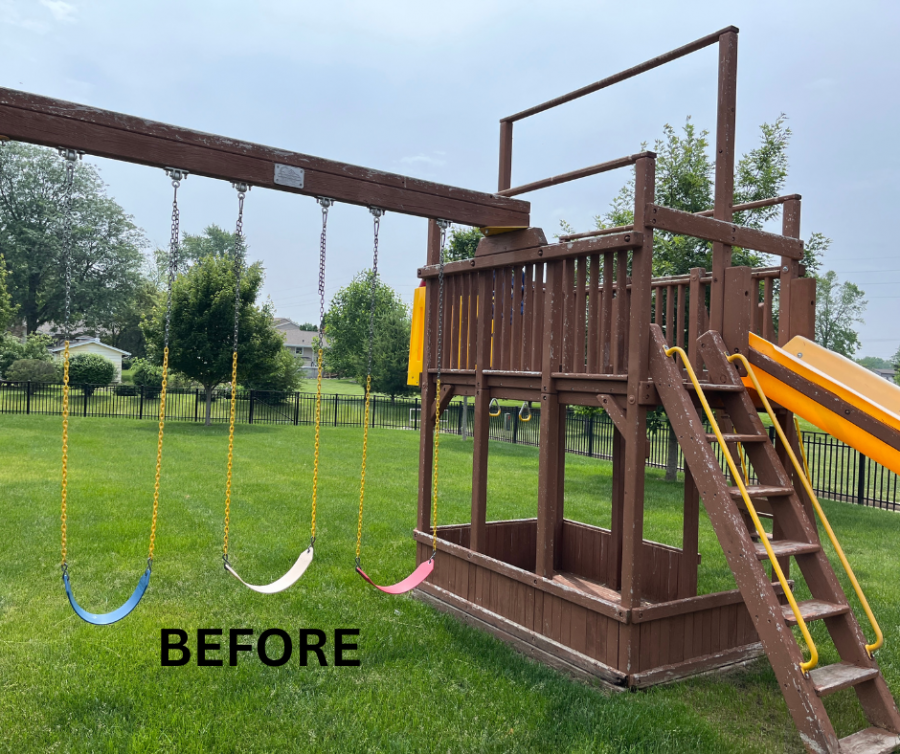 wooden playset with worn staining in grass behind house Preview Image 1