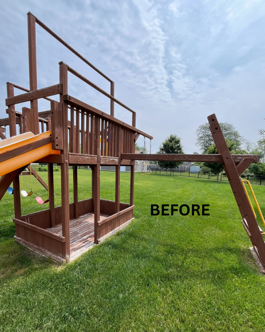 wooden playset with worn staining in grass behind house Preview Image 3