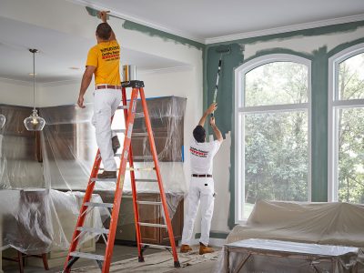 Team of CertaPro Painters Painting a living room