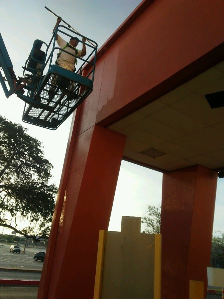 painter in boom lift working on exterior of storefront Preview Image 6