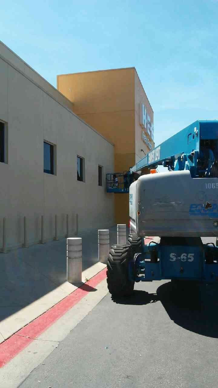 boom lift with painter adding paint to exterior of commercial building Preview Image 8