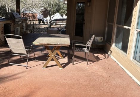 concrete walkway with worn red paint