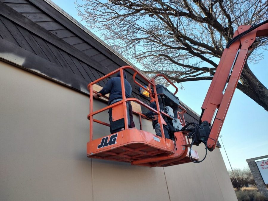 painters in boom lift working on trim of building Preview Image 2