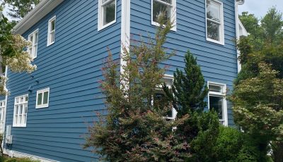 exterior of a two story home painted blue by certapro painters