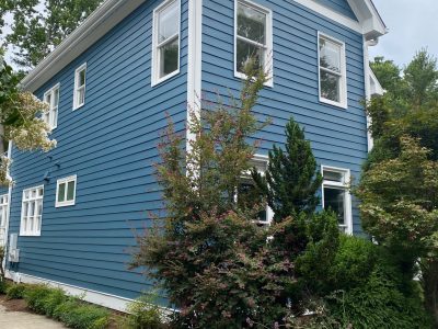 exterior of a two story home painted blue by certapro painters