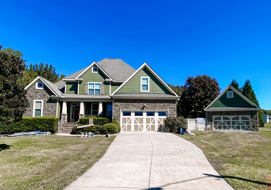 large home with a long driveway after exterior painting
