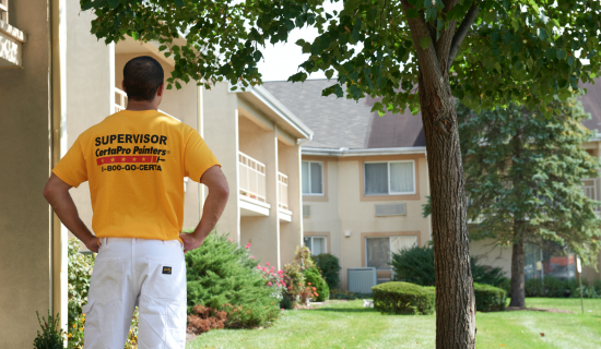 certapro painter team member outside commercial hoa building
