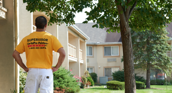 certapro painter team member outside commercial hoa building