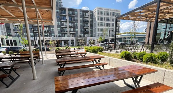 stained wooden picnic tables on restaurant patio