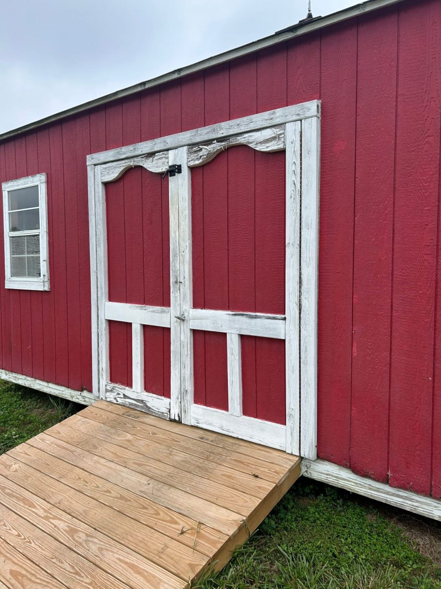 red shed with worn red paint and white trim Preview Image 1