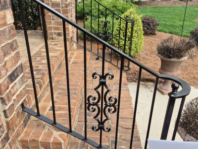 exterior brick steps with black painted metal railing
