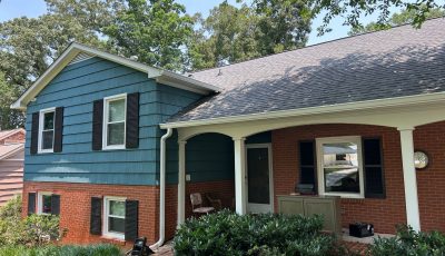 split level house with brick and blue painted siding
