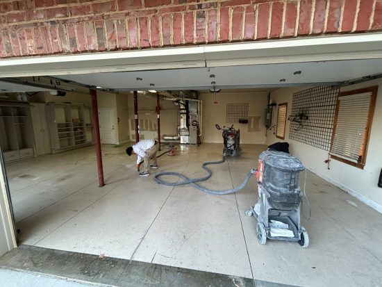 certapro painter using vaccum on garage floor