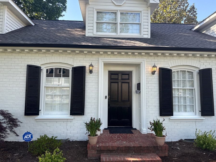white painted brick house with black accents and trim