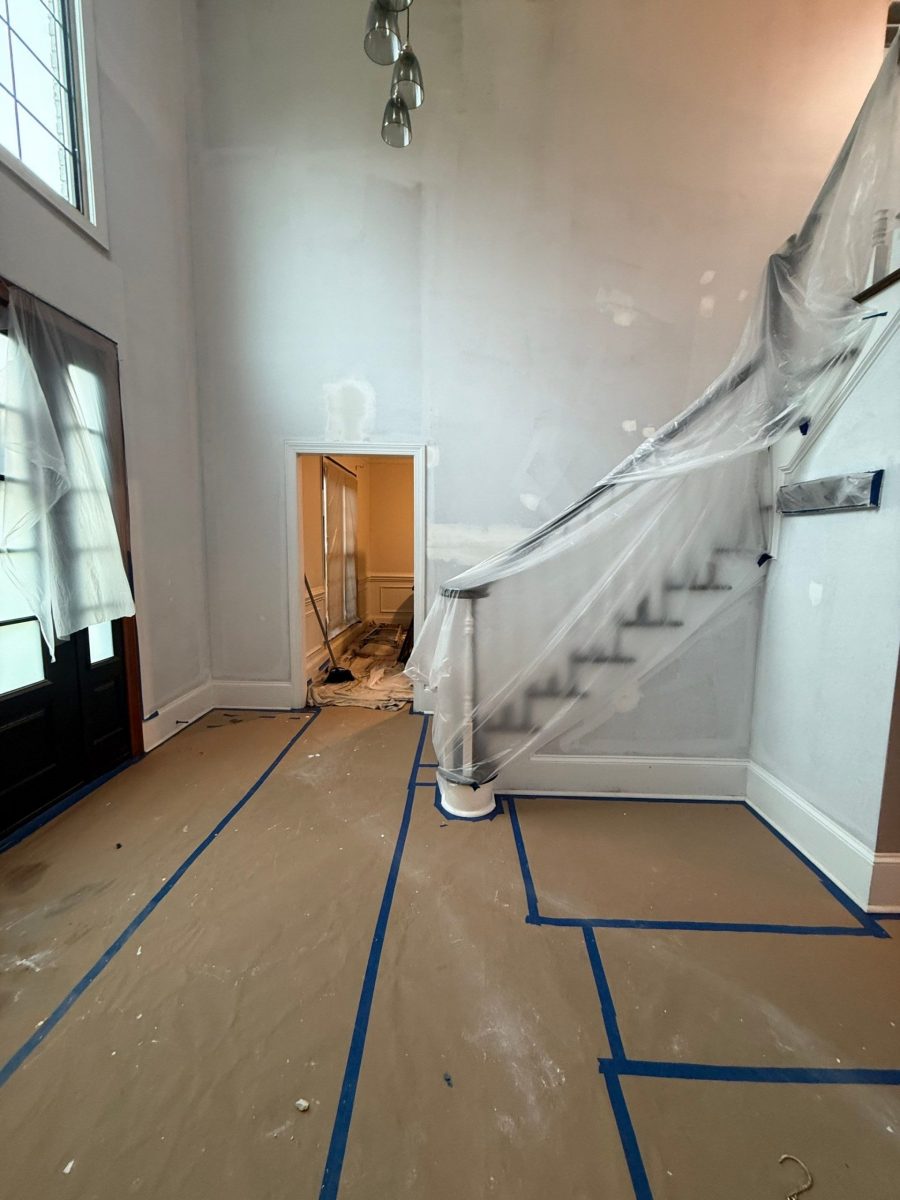 home stairwell with protective coverings on floors and banister during painting Preview Image 1