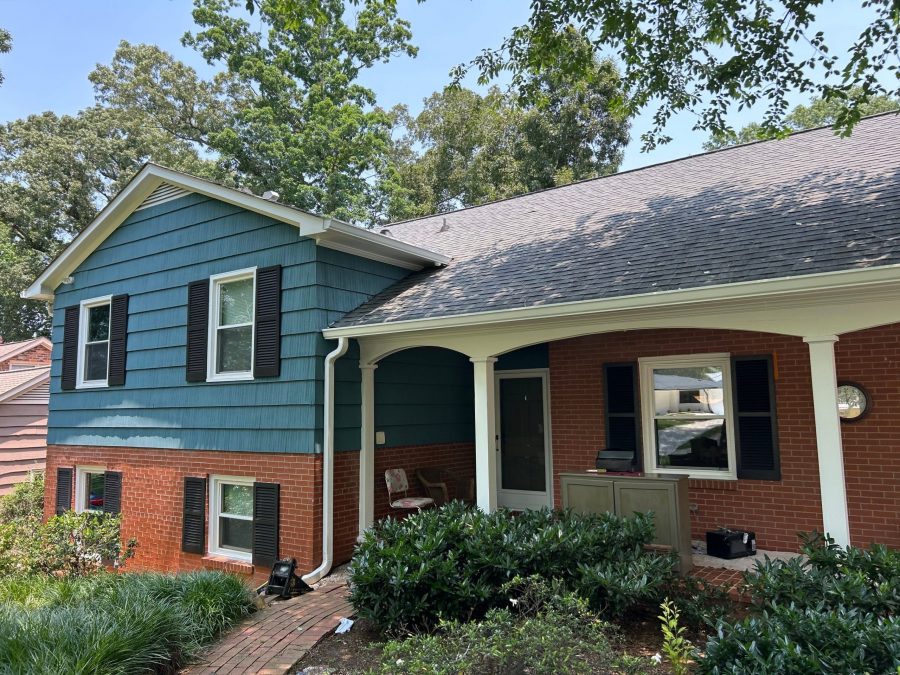 split level house with brick and blue painted siding