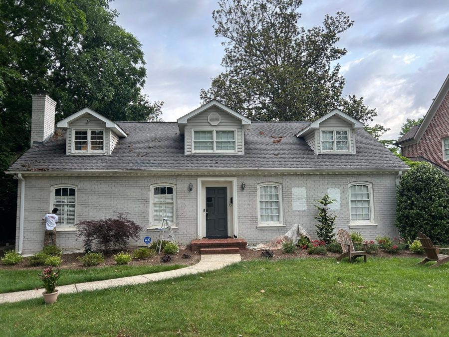 front of brick house with worn and damaged grey paint Preview Image 1