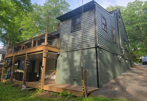 rear view of house with painted siding and brick