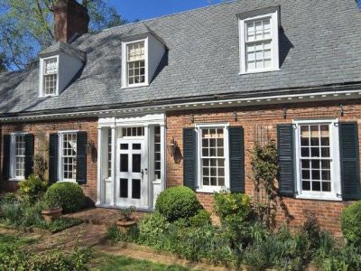 brick home exterior with painted trim and shutters