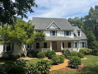 street view of house with white painted siding and blue shutters