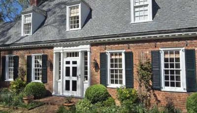 brick home exterior with painted trim and shutters