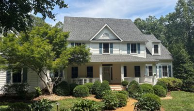 street view of house with white painted siding and blue shutters