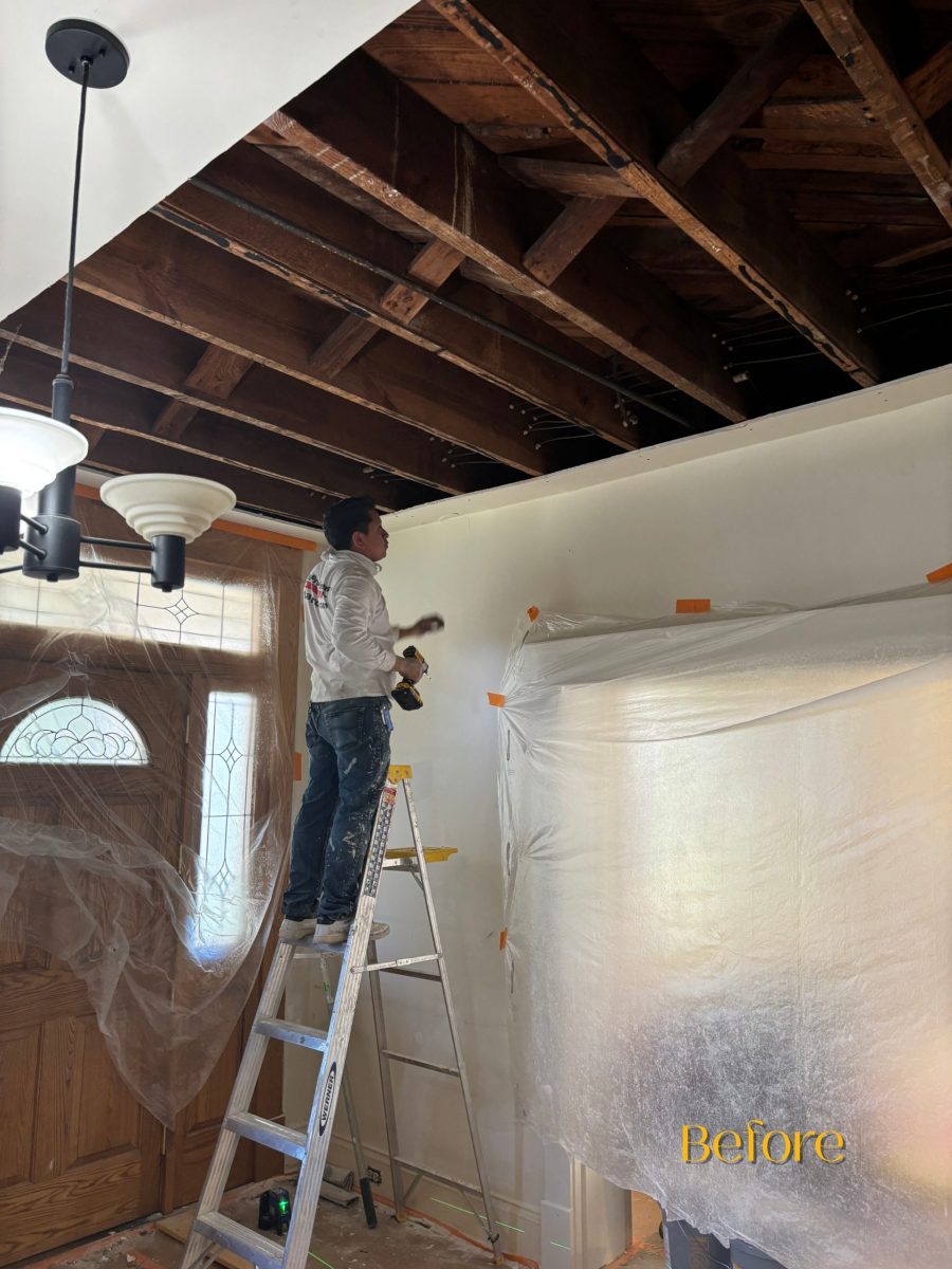 painter on ladder with exposed ceiling beams Preview Image 4