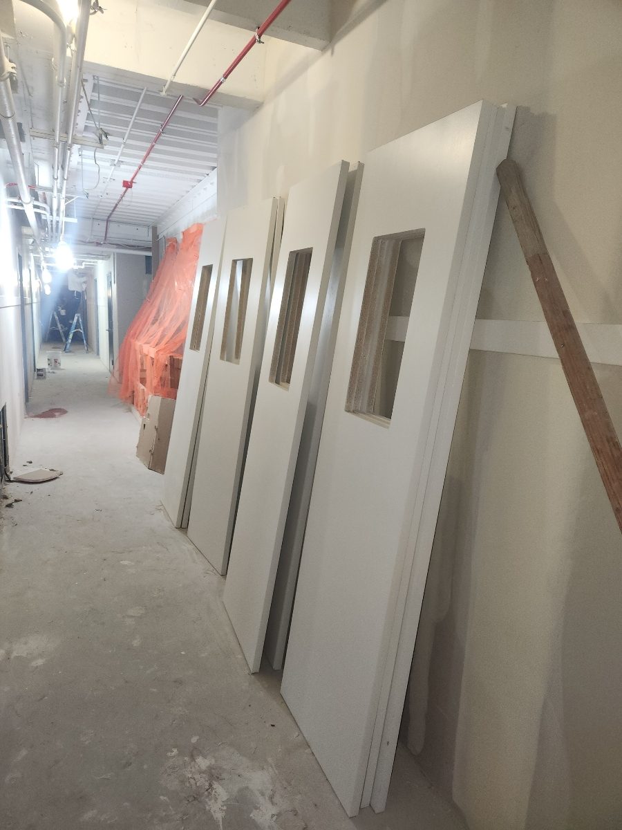 row of uninstalled newly painted doors for apartment complex in chicago Preview Image 1