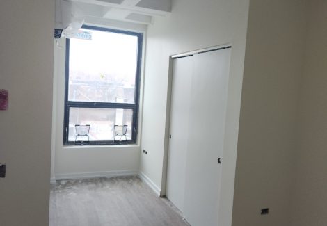 newly painted empty apartment room with window on Broadway Chicago IL