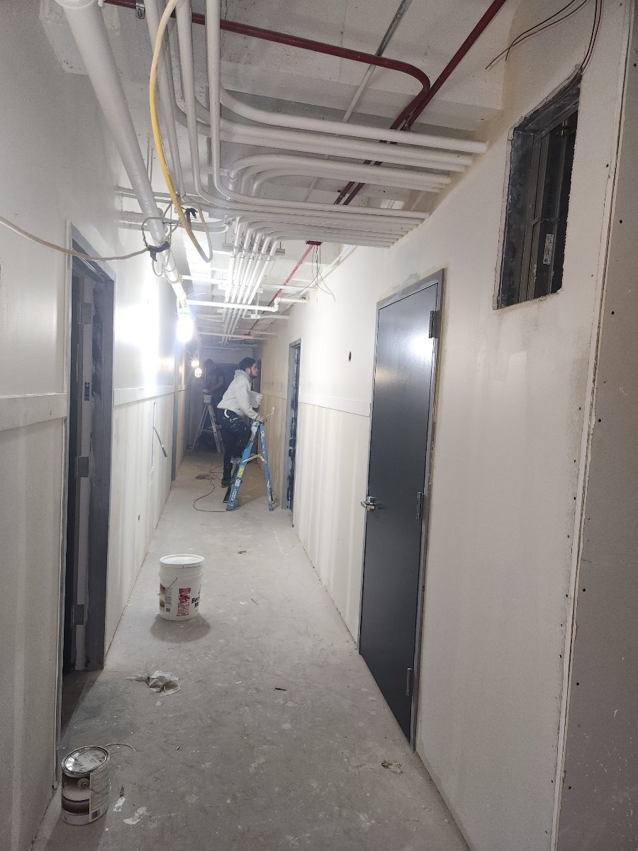 professional painter during painting process in an apartment complex hallway on Broadway Chicago Preview Image 2
