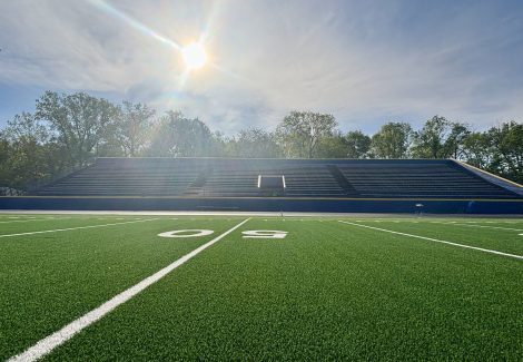painted high school football field and stadium seats