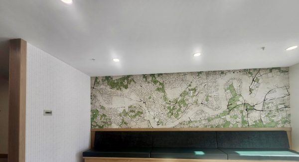 green upholstered bench with wallpapered wall