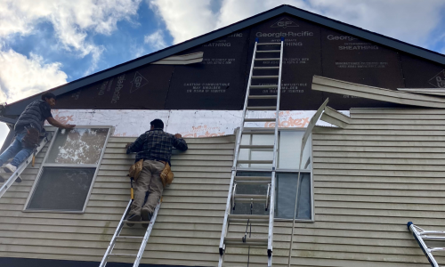 Florence Exterior Home project view of siding being prepared and painted