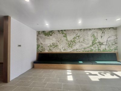 green upholstered bench with wallpapered wall
