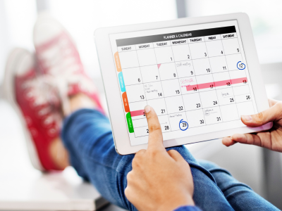 a person holding a tablet showing a schedule