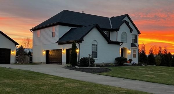 large painted home at sunset