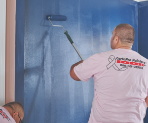 CertaPro Painters® team meber interior painting a wall