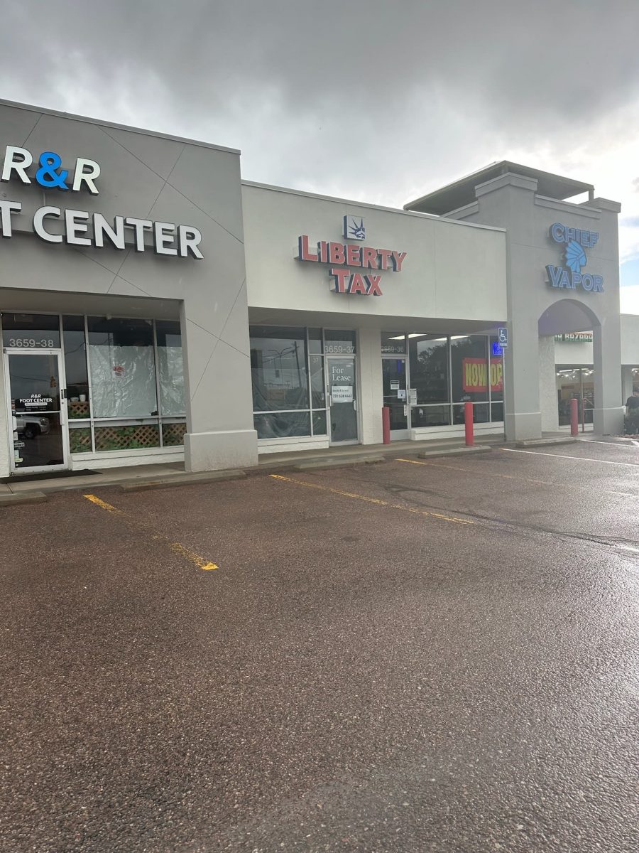 parking lot and storefronts of painted shopping center Preview Image 1
