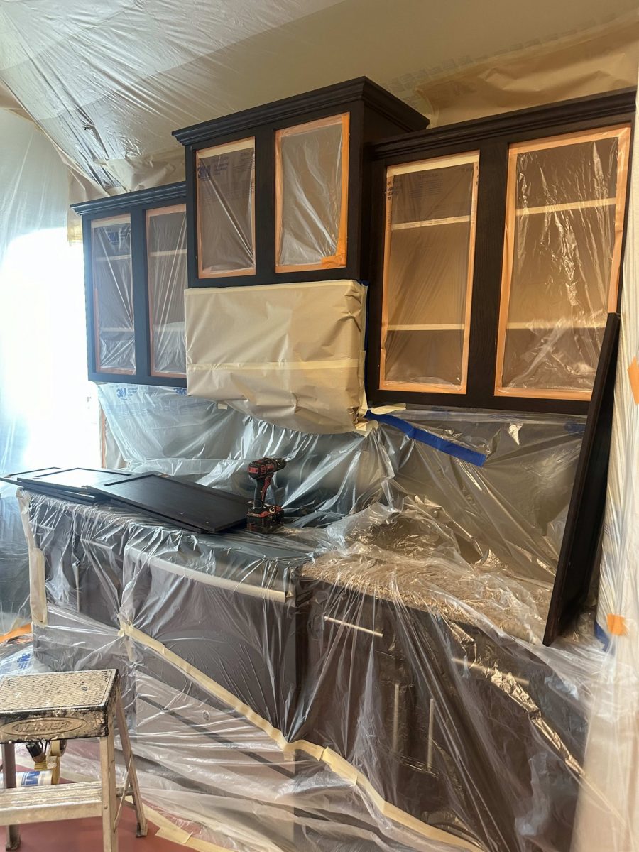 kitchen cabinets with doors removed for painting, and protective sheeting over lower cabinets Preview Image 2