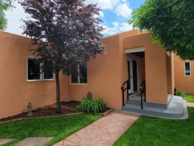 front of painted stucco house with front door