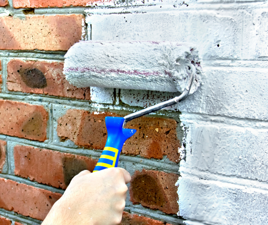 white roller on a brick painting projet