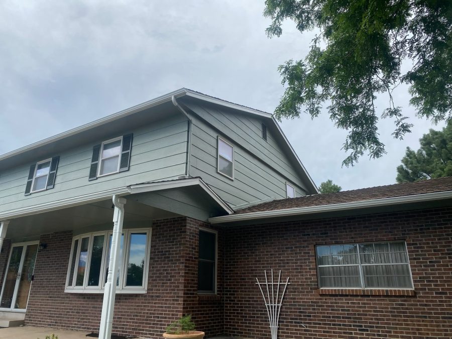 front of house with brick and green siding Preview Image 3